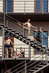 Image showing The group of modern ballet dancers performing on the stairs at the city