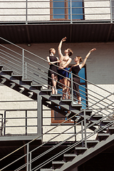 Image showing The group of modern ballet dancers performing on the stairs at the city