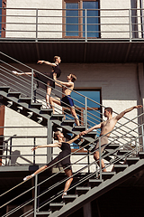Image showing The group of modern ballet dancers performing on the stairs at the city