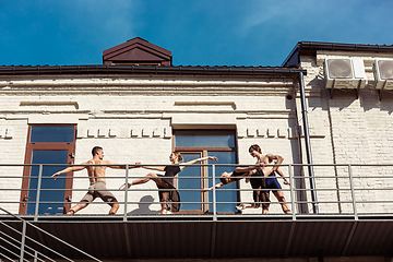 Image showing The group of modern ballet dancers performing on the stairs at the city