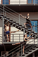 Image showing The group of modern ballet dancers performing on the stairs at the city