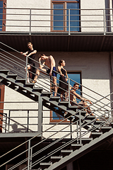 Image showing The group of modern ballet dancers performing on the stairs at the city