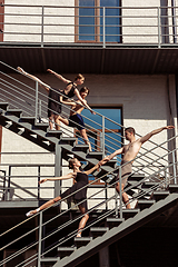 Image showing The group of modern ballet dancers performing on the stairs at the city