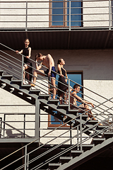 Image showing The group of modern ballet dancers performing on the stairs at the city