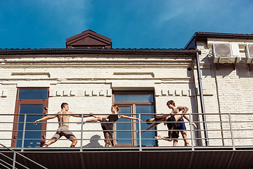 Image showing The group of modern ballet dancers performing on the stairs at the city