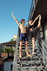 Image showing Couple of modern ballet dancers performing on the stairs at the city