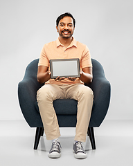 Image showing happy indian man with tablet pc computer in chair