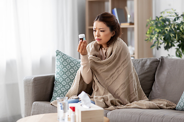 Image showing sick asian woman with medicine at home