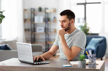 Image showing man with laptop working at home office