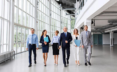 Image showing business people walking along office building