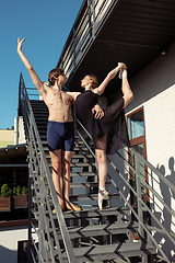 Image showing Couple of modern ballet dancers performing on the stairs at the city