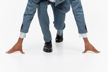 Image showing Man in office clothes running, jogging on white background. Unusual look for businessman in motion, action. Sport, healthy lifestyle.