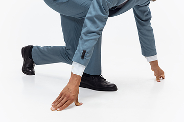 Image showing Man in office clothes running, jogging on white background. Unusual look for businessman in motion, action. Sport, healthy lifestyle.