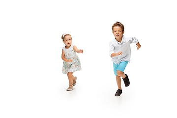 Image showing Happy children, little caucasian boy and girl jumping and running isolated on white background