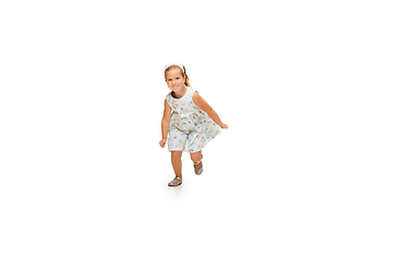 Image showing Happy little caucasian girl jumping and running isolated on white background