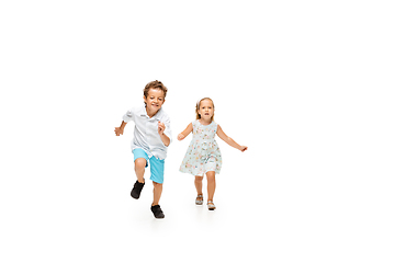 Image showing Happy children, little caucasian boy and girl jumping and running isolated on white background