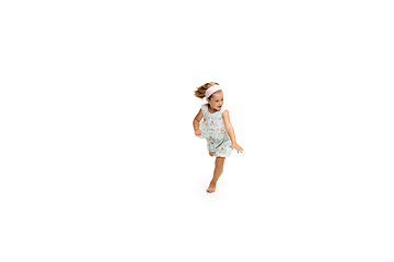 Image showing Happy little caucasian girl jumping and running isolated on white background