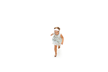 Image showing Happy little caucasian girl jumping and running isolated on white background