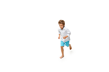 Image showing Happy little caucasian boy jumping and running isolated on white background