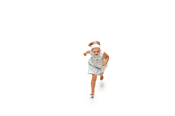 Image showing Happy little caucasian girl jumping and running isolated on white background