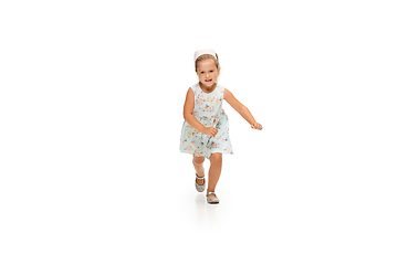 Image showing Happy little caucasian girl jumping and running isolated on white background