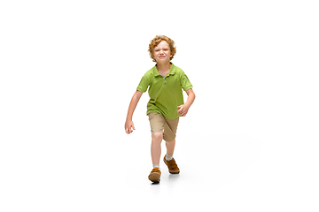 Image showing Happy little caucasian boy jumping and running isolated on white background