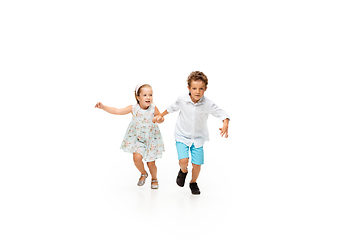 Image showing Happy children, little caucasian boy and girl jumping and running isolated on white background