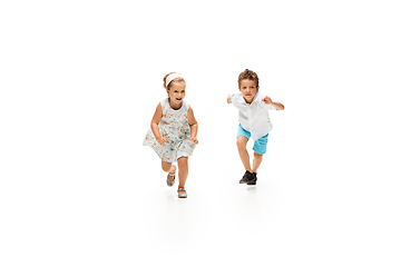 Image showing Happy children, little caucasian boy and girl jumping and running isolated on white background