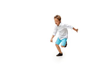 Image showing Happy little caucasian boy jumping and running isolated on white background