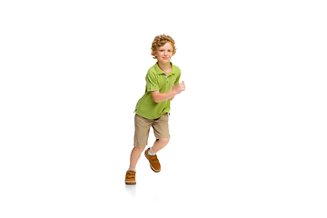 Image showing Happy little caucasian boy jumping and running isolated on white background