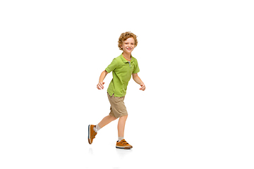 Image showing Happy little caucasian boy jumping and running isolated on white background