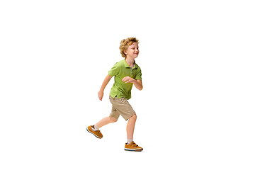 Image showing Happy little caucasian boy jumping and running isolated on white background