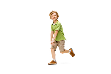 Image showing Happy little caucasian boy jumping and running isolated on white background
