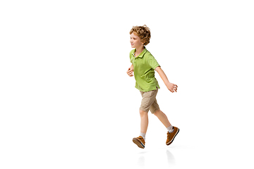 Image showing Happy little caucasian boy jumping and running isolated on white background