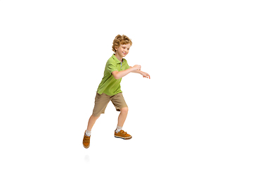 Image showing Happy little caucasian boy jumping and running isolated on white background