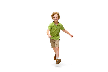 Image showing Happy little caucasian boy jumping and running isolated on white background