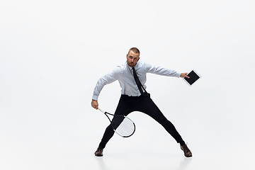 Image showing Time for movement. Man in office clothes plays tennis isolated on white studio background.