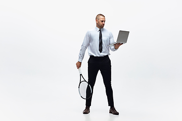 Image showing Time for movement. Man in office clothes plays tennis isolated on white studio background.