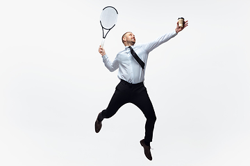 Image showing Time for movement. Man in office clothes plays tennis isolated on white studio background.