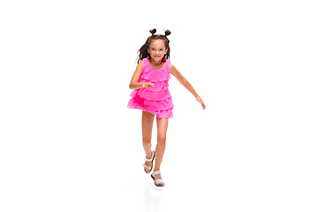 Image showing Happy little caucasian girl jumping and running isolated on white background