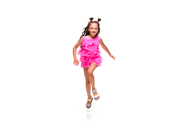 Image showing Happy little caucasian girl jumping and running isolated on white background