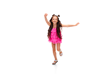 Image showing Happy little caucasian girl jumping and running isolated on white background