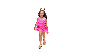 Image showing Happy little caucasian girl jumping and running isolated on white background
