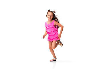 Image showing Happy little caucasian girl jumping and running isolated on white background