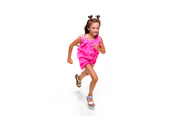 Image showing Happy little caucasian girl jumping and running isolated on white background