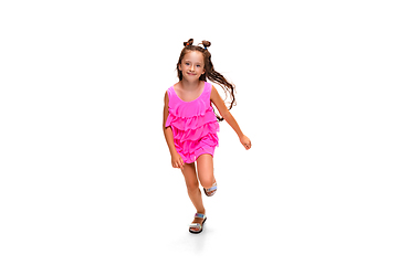 Image showing Happy little caucasian girl jumping and running isolated on white background