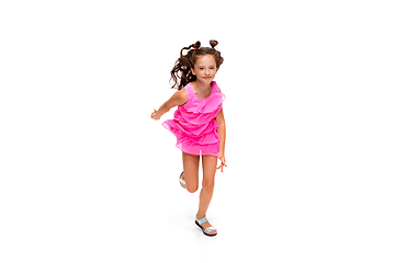 Image showing Happy little caucasian girl jumping and running isolated on white background