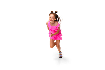 Image showing Happy little caucasian girl jumping and running isolated on white background