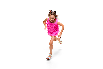 Image showing Happy little caucasian girl jumping and running isolated on white background