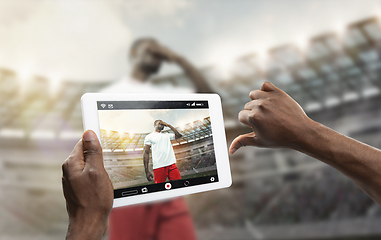 Image showing Close up hands holding tablet viewing sport, online translation, streaming of championship